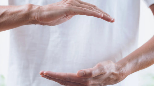 Séance de Reiki avec un praticien positionnant ses mains au-dessus du corps